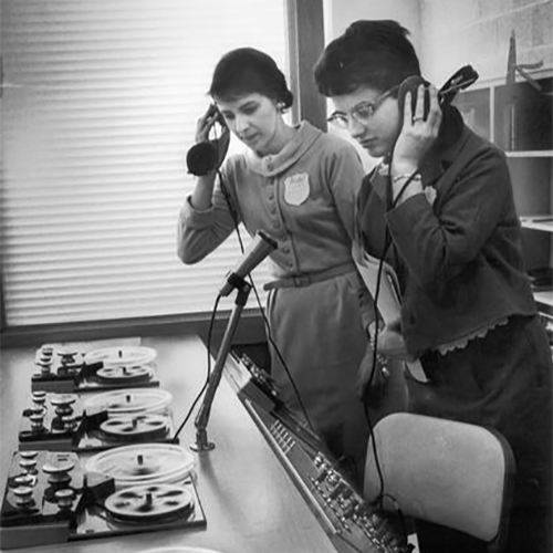 Language teachers listen to foreign languages on tape decks at an institute for public school language teachers at Mount Mary College.